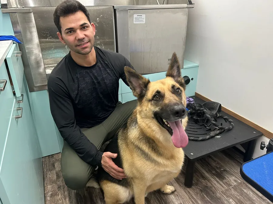 Luna groomer with a happy German shepherd
